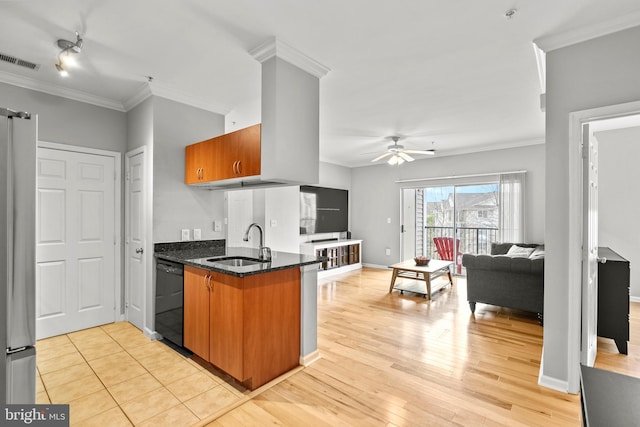 kitchen featuring a sink, freestanding refrigerator, visible vents, brown cabinets, and dishwasher