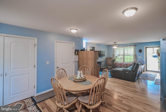 dining area with ceiling fan and light wood-type flooring