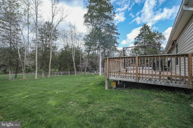 view of yard with a wooden deck and fence