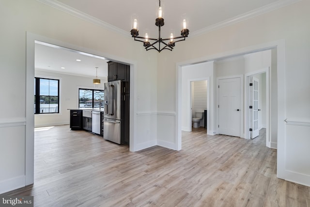 14671 Banks Odee Rd, Newburg, MD 20664 - unfurnished dining area featuring baseboards, ornamental molding, a chandelier, and light wood-type flooring