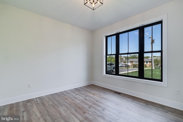14671 Banks Odee Rd, Newburg, MD 20664 - spare room with wood finished floors, visible vents, baseboards, and an inviting chandelier