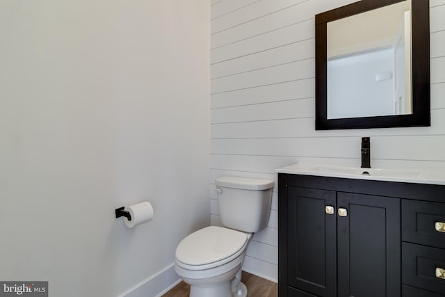 14671 Banks Odee Rd, Newburg, MD 20664 - half bathroom featuring baseboards, wood finished floors, vanity, and toilet