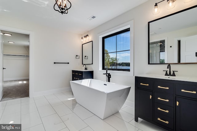 14671 Banks Odee Rd, Newburg, MD 20664 - bathroom featuring a sink, a soaking tub, baseboards, two vanities, and visible vents