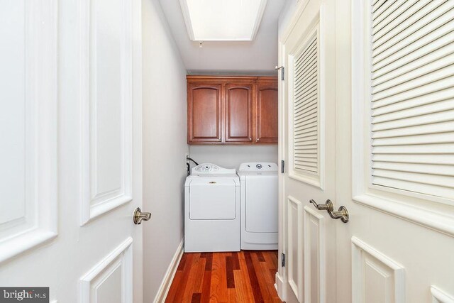 2108 Points Reach, Berlin, MD 21811 - washroom featuring washer and dryer, cabinet space, dark wood-style flooring, and baseboards