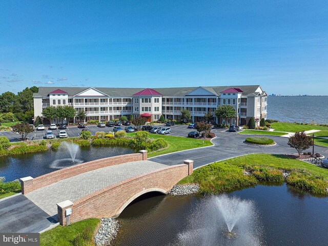 2108 Points Reach, Berlin, MD 21811 - view of building exterior with uncovered parking and a water view