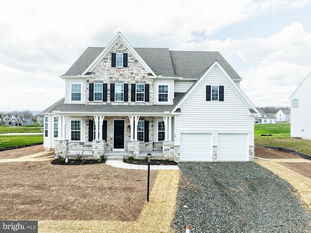 75 Cori Dr, Gilbertsville, PA 19525 - view of front of house featuring gravel driveway, a porch, stone siding, and a shingled roof