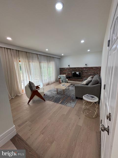 1242 Clearfield Cir, Lutherville Timonium, MD 21093 - living room featuring a fireplace, baseboards, wood finished floors, and recessed lighting