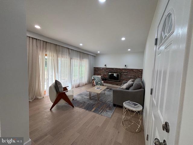 1242 Clearfield Cir, Lutherville Timonium, MD 21093 - living room featuring recessed lighting, wood finished floors, and a brick fireplace
