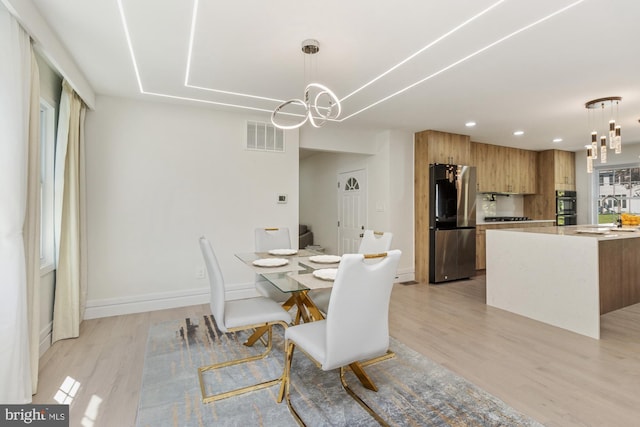 1242 Clearfield Cir, Lutherville Timonium, MD 21093 - dining area featuring light wood finished floors, baseboards, visible vents, and a chandelier