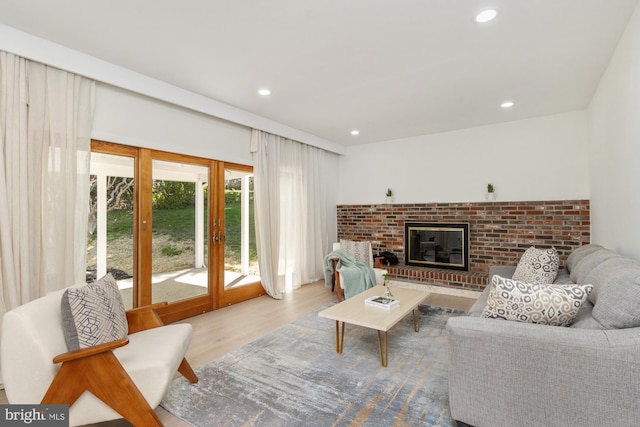 1242 Clearfield Cir, Lutherville Timonium, MD 21093 - living room with a brick fireplace, wood finished floors, and recessed lighting