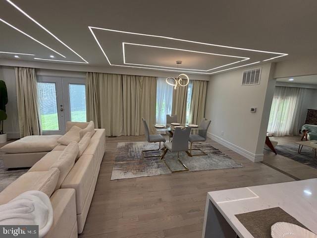 1242 Clearfield Cir, Lutherville Timonium, MD 21093 - dining area featuring wood finished floors, visible vents, french doors, baseboards, and a notable chandelier
