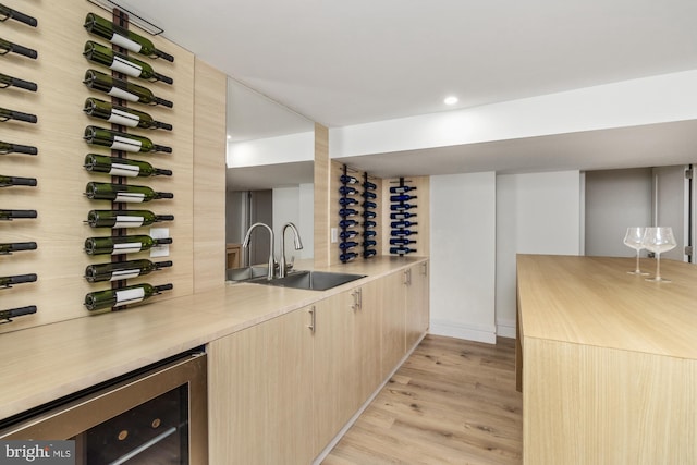 1242 Clearfield Cir, Lutherville Timonium, MD 21093 - wine room featuring a sink, baseboards, recessed lighting, light wood-style floors, and beverage cooler