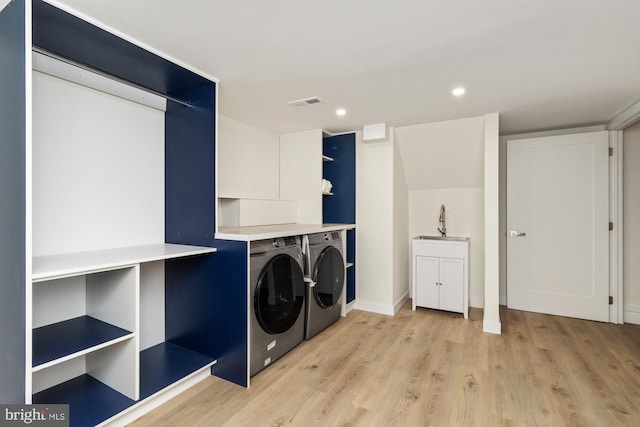1242 Clearfield Cir, Lutherville Timonium, MD 21093 - washroom with washing machine and clothes dryer, a sink, light wood finished floors, visible vents, and recessed lighting