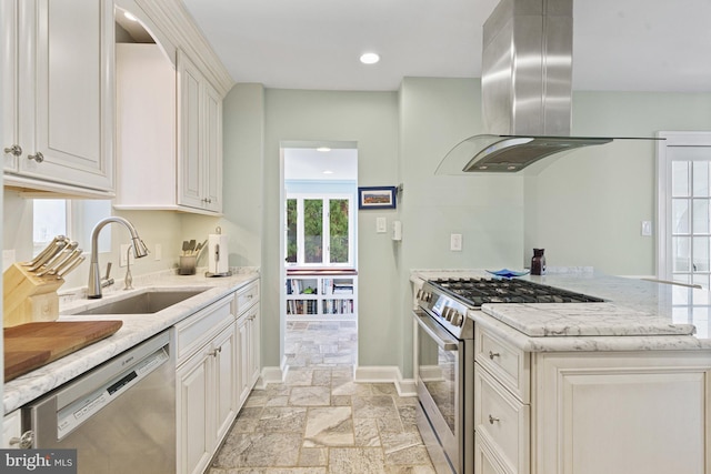 kitchen featuring stainless steel appliances, island exhaust hood, a sink, stone tile floors, and light stone counters