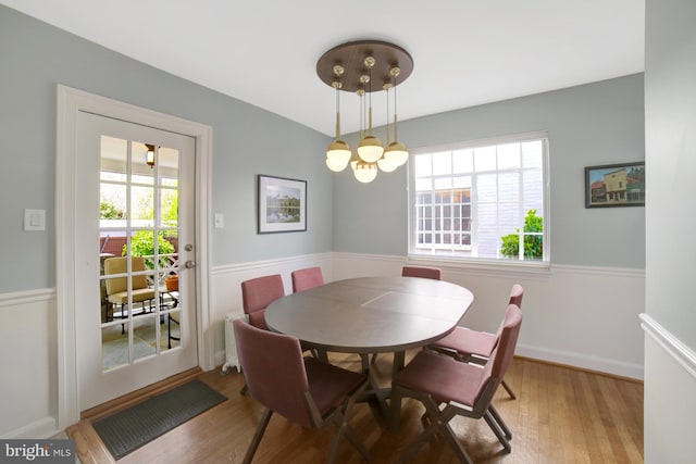 dining space featuring wood finished floors and baseboards