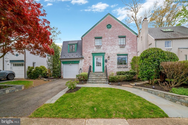view of front of property featuring a front lawn, brick siding, driveway, and an attached garage