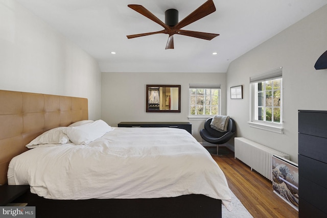 bedroom featuring radiator, wood finished floors, a ceiling fan, and recessed lighting