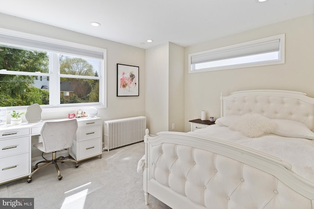 bedroom featuring light colored carpet, radiator heating unit, and recessed lighting