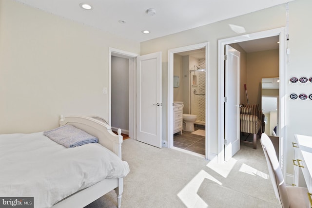 bedroom featuring baseboards, recessed lighting, light colored carpet, and connected bathroom
