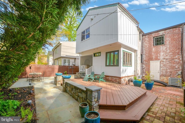 rear view of house featuring cooling unit, a patio area, and fence