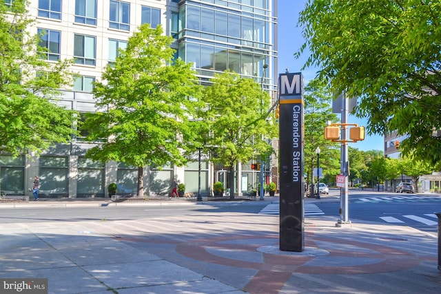 exterior space featuring curbs, sidewalks, and traffic lights