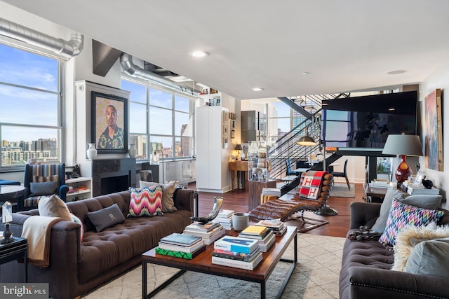 2200 Arch St Unit 1204, Philadelphia, PA 19103 - living room with recessed lighting, a city view, stairs, and wood finished floors