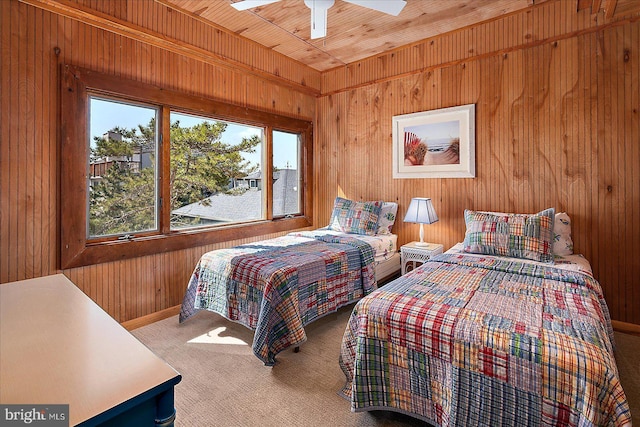 carpeted bedroom featuring wood walls, wood ceiling, and a ceiling fan