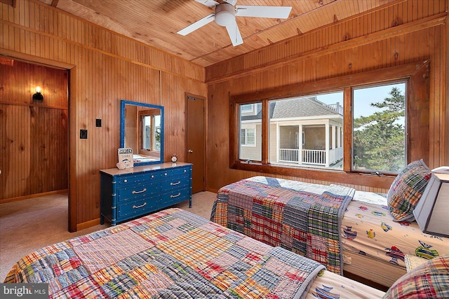 bedroom featuring wood walls, light colored carpet, and wood ceiling