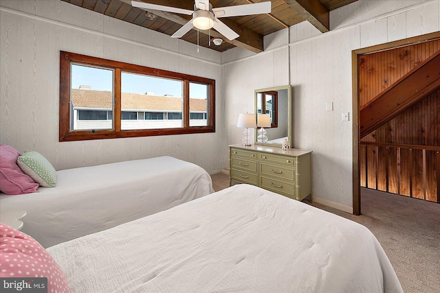 carpeted bedroom with wooden ceiling, beamed ceiling, and a ceiling fan
