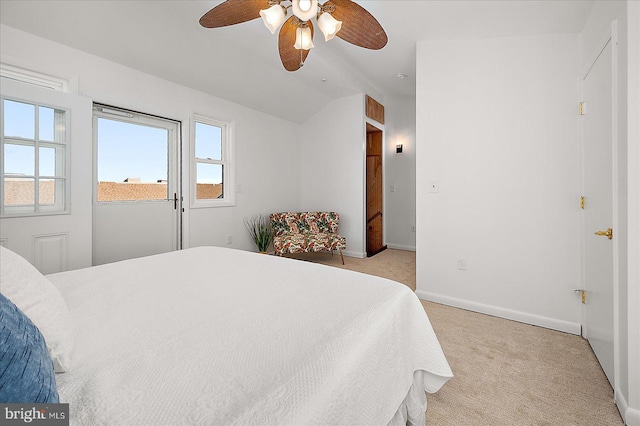 bedroom featuring baseboards, ceiling fan, light colored carpet, and vaulted ceiling