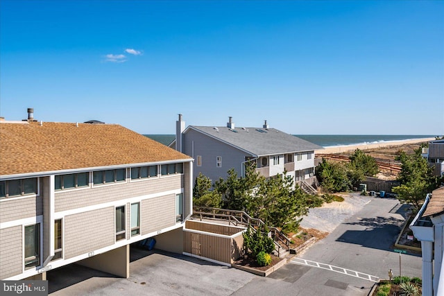 exterior space featuring a view of the beach and a water view