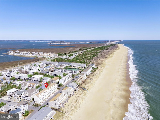 drone / aerial view featuring a water view and a beach view