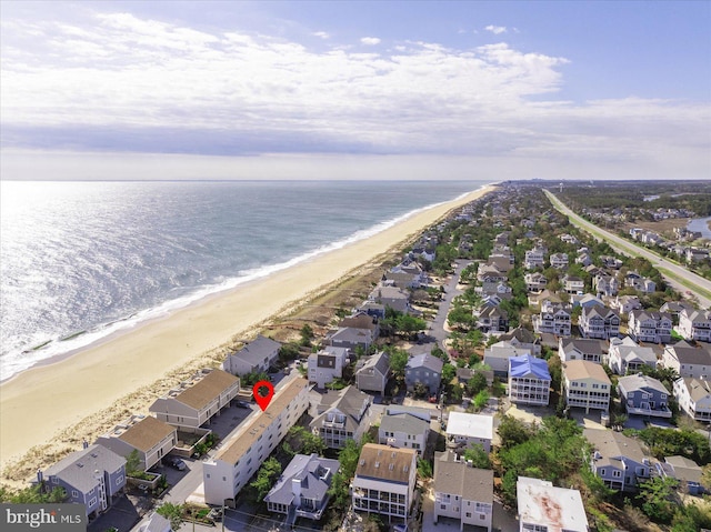 aerial view featuring a water view, a beach view, and a residential view