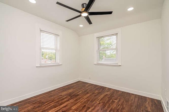 spare room with dark wood-style floors, recessed lighting, baseboards, ceiling fan, and vaulted ceiling
