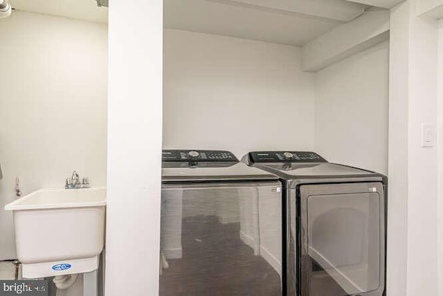 washroom featuring independent washer and dryer and a sink
