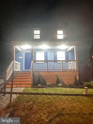 back of house featuring a porch
