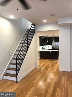 2025 N Woodstock St, Philadelphia, PA 19121 - staircase featuring recessed lighting, baseboards, a ceiling fan, and wood finished floors
