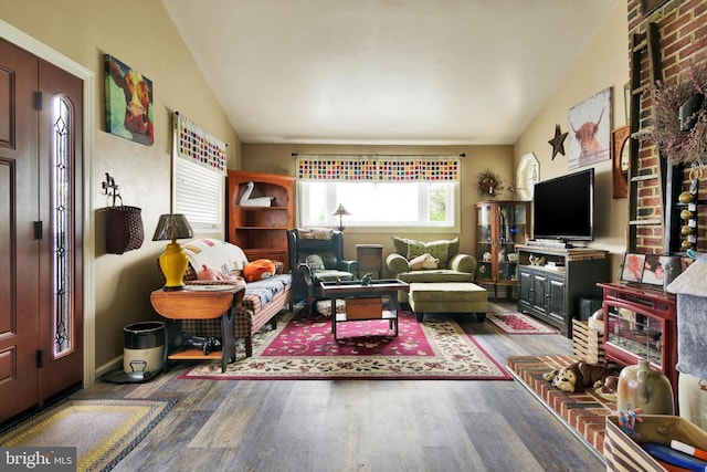 living area featuring wood finished floors and lofted ceiling