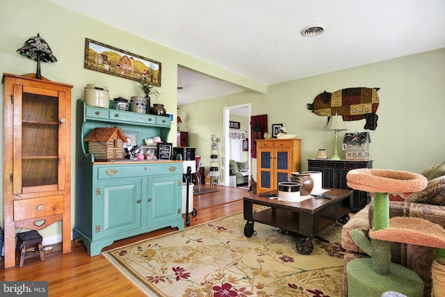 living room featuring visible vents and light wood finished floors
