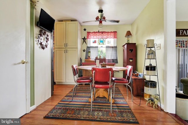 dining area with a ceiling fan and light wood-type flooring