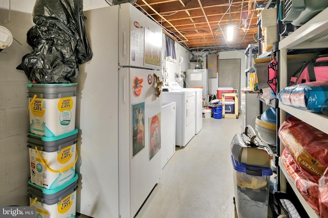 unfinished below grade area featuring washer and dryer and freestanding refrigerator