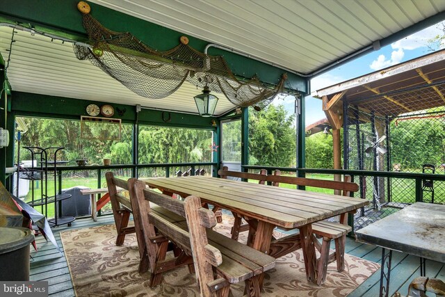 sunroom / solarium featuring outdoor dining space
