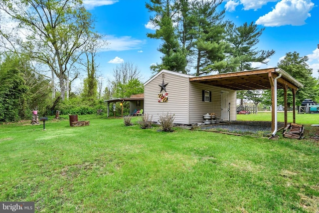 view of yard featuring driveway and an attached carport