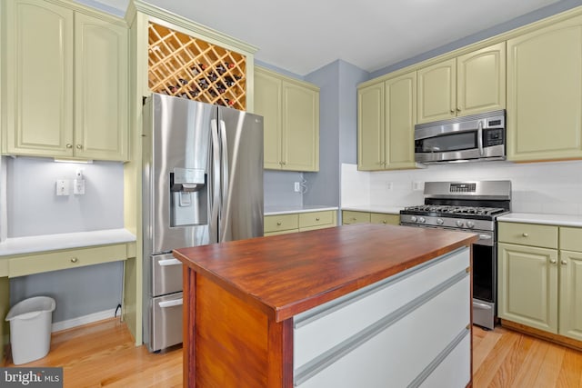 15008 Seneca Knoll Way, Haymarket, VA 20169 - kitchen with butcher block countertops, stainless steel appliances, backsplash, light wood-style flooring, and a kitchen island