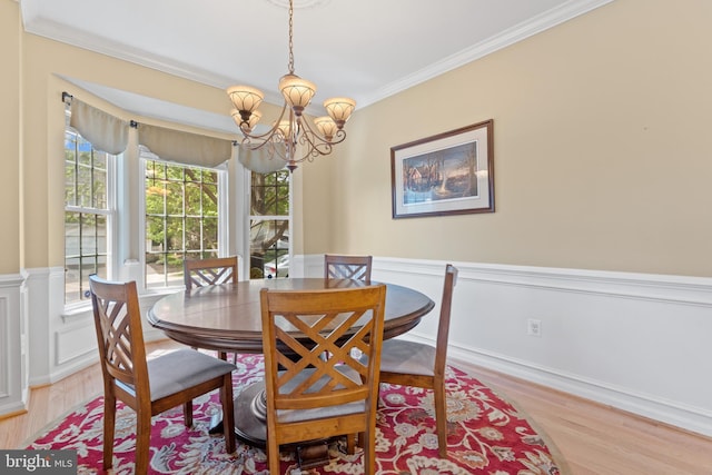 15008 Seneca Knoll Way, Haymarket, VA 20169 - dining room with wood finished floors, a chandelier, crown molding, and wainscoting