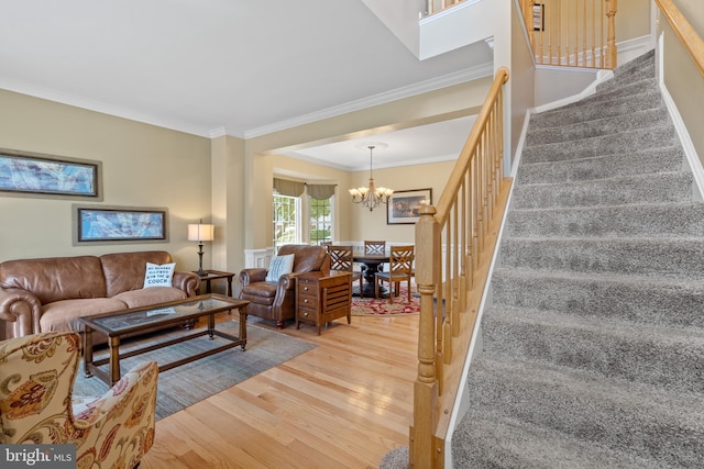 15008 Seneca Knoll Way, Haymarket, VA 20169 - living room with stairway, a chandelier, crown molding, and light wood finished floors