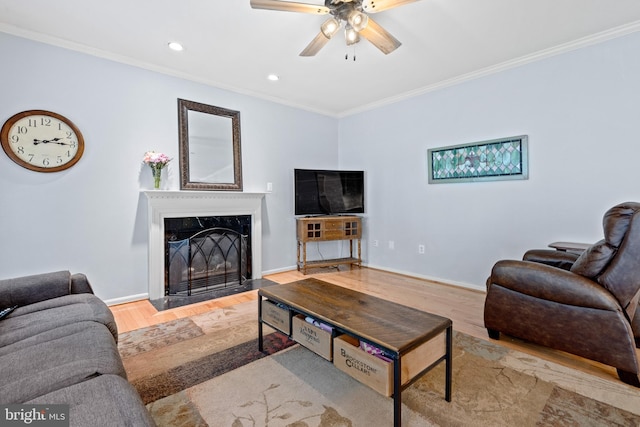 15008 Seneca Knoll Way, Haymarket, VA 20169 - living room with crown molding, a high end fireplace, baseboards, wood finished floors, and a ceiling fan