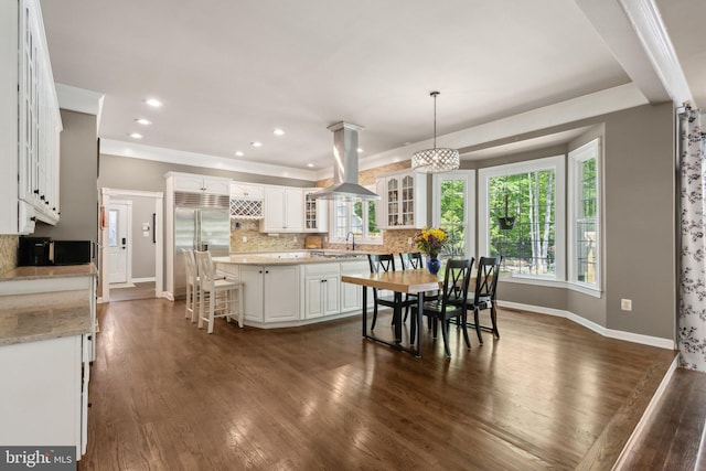 6601 Rutledge Dr, Fairfax Station, VA 22039 - dining room with baseboards, dark wood-style flooring, and a healthy amount of sunlight
