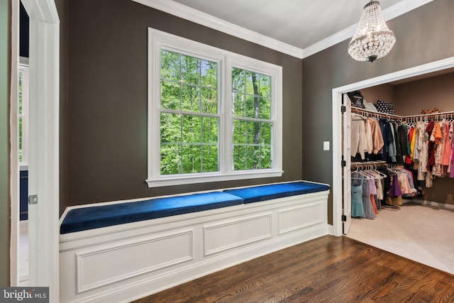 6601 Rutledge Dr, Fairfax Station, VA 22039 - walk in closet with an inviting chandelier and dark wood-style flooring