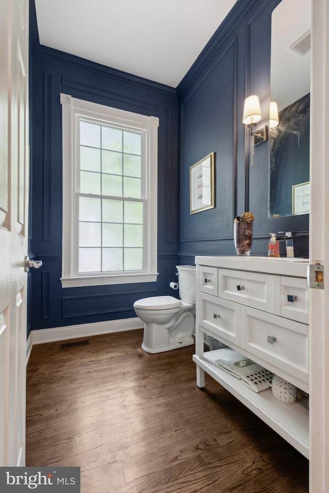 6601 Rutledge Dr, Fairfax Station, VA 22039 - half bath featuring vanity, a decorative wall, toilet, and visible vents